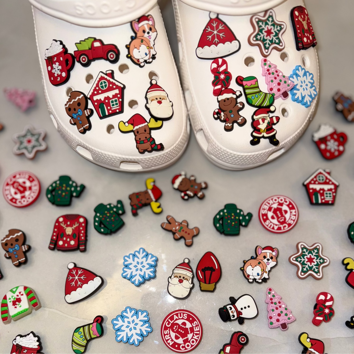 White shoes with Christmas-themed decorations on an additional Christmas charms.